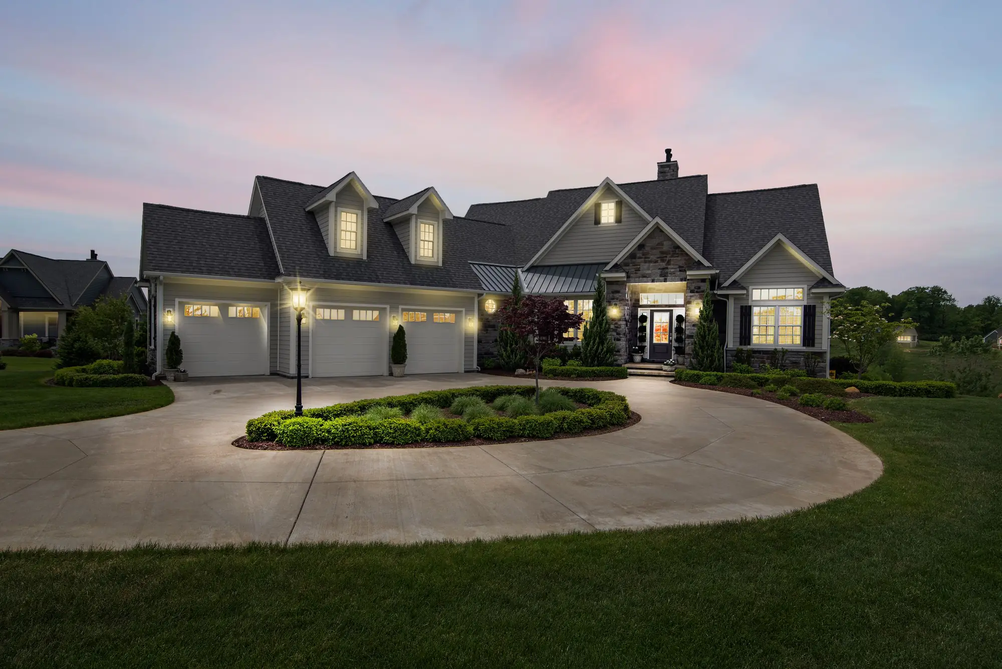A home at dusk with every window lit